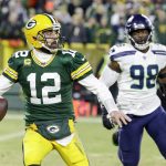 Green Bay Packers' Aaron Rodgers scrambles during the first half of an NFL divisional playoff football game against the Seattle Seahawks Sunday, Jan. 12, 2020, in Green Bay, Wis. (AP Photo/Darron Cummings)