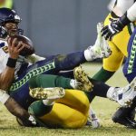 Green Bay Packers' Preston Smith sacks Seattle Seahawks' Russell Wilson during the second half of an NFL divisional playoff football game Sunday, Jan. 12, 2020, in Green Bay, Wis. (AP Photo/Matt Ludtke)