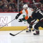 Philadelphia Flyers' Kevin Hayes (13) chases down the puck against Arizona Coyotes' Jakob Chychrun (6) during the first period of an NHL hockey game Saturday, Jan. 4, 2020, in Glendale, Ariz. (AP Photo/Darryl Webb)