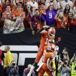 Clemson wide receiver Amari Rodgers celebrates after scoring with wide receiver Joe Ngata during the second half of a NCAA College Football Playoff national championship game against LSU, Monday, Jan. 13, 2020, in New Orleans. (AP Photo/Sue Ogrocki)