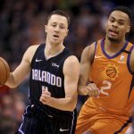 Orlando Magic's Josh Magette (4) drives to the basket around Phoenix Suns' Elie Okobo (2) during the first half of an NBA basketball game Friday, Jan. 10, 2020, in Phoenix. (AP Photo/Darryl Webb)