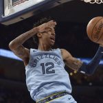 Memphis Grizzlies guard Ja Morant (12) finishes a dunk in the first half of an NBA basketball game against the Phoenix Suns, Sunday, Jan. 26, 2020, in Memphis, Tenn. (AP Photo/Brandon Dill)