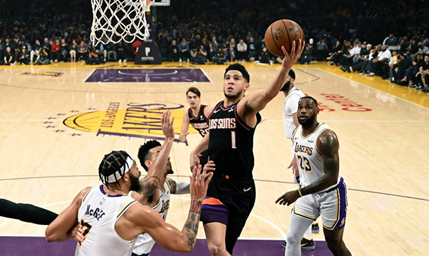 Phoenix Suns' Devin Booker (1) drives to basket against the Los Angeles Lakers during the first hal...