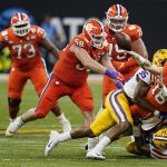 Clemson quarterback Trevor Lawrence passes under pressure against LSU during the first half of a NCAA College Football Playoff national championship game Monday, Jan. 13, 2020, in New Orleans. (AP Photo/David J. Phillip)