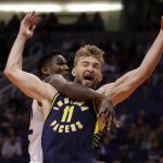 Indiana Pacers forward Domantas Sabonis (11) is fouled by Phoenix Suns center Deandre Ayton during the first half of an NBA basketball game, Wednesday, Jan. 22, 2020, in Phoenix. (AP Photo/Matt York)