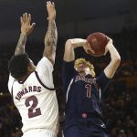 Arizona guard Nico Mannion (1) shoots over Arizona State guard Rob Edwards (2) during the first half of an NCAA college basketball game Saturday, Jan. 25, 2020, in Tempe, Ariz. (AP Photo/Ross D. Franklin)
