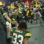 Green Bay Packers' Aaron Jones celebrates with fans after an NFL divisional playoff football game against the Seattle Seahawks Sunday, Jan. 12, 2020, in Green Bay, Wis. The Packers won 28-23 to advance to the NFC Championship. (AP Photo/Mike Roemer)