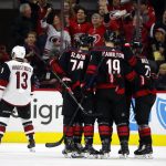 Carolina Hurricanes celebrate a goal by Lucas Wallmark, right, during the second period of an NHL hockey game against the Arizona Coyotes in Raleigh, N.C., Friday, Jan. 10, 2020. (AP Photo/Karl B DeBlaker)