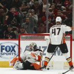 Anaheim Ducks goaltender John Gibson (36) gives up a goal to Arizona Coyotes' Lawson Crouse as Anaheim Ducks defenseman Hampus Lindholm (47) pauses in front of the net during the first period of an NHL hockey game Thursday, Jan. 2, 2020, in Glendale, Ariz. (AP Photo/Ross D. Franklin)