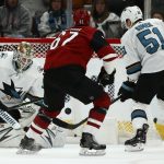 San Jose Sharks goaltender Aaron Dell, left, makes a save on a shot by Arizona Coyotes left wing Lawson Crouse (67) as Sharks defenseman Radim Simek (51) arrives to help with the loose puck during the first period of an NHL hockey game Tuesday, Jan. 14, 2020, in Glendale, Ariz. (AP Photo/Ross D. Franklin)