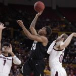 Colorado guard Eli Parquet (24) shoots between Arizona State guard Remy Martin (1) and Arizona State forward Mickey Mitchell during the first half of an NCAA college basketball game, Thursday, Jan. 16, 2020, in Tempe, Ariz. (AP Photo/Matt York)
