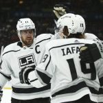 Los Angeles Kings left wing Alex Iafallo (19) celebrates his goal against the Arizona Coyotes with center Anze Kopitar, left, and defenseman Ben Hutton, back right, during the first period of an NHL hockey game Thursday, Jan. 30, 2020, in Glendale, Ariz. (AP Photo/Ross D. Franklin)