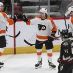 Philadelphia Flyers' Justin Braun (61) gets high-fives from teammate Travis Konecny (11) as Sean Couturier (14) approaches, after a goal against the Arizona Coyotes during the third period of an NHL hockey game Saturday, Jan. 4, 2020, in Glendale, Ariz. (AP Photo/Darryl Webb)