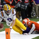 LSU quarterback Joe Burrow is tackled by LSU defensive back Maurice Hampton Jr. during the first half of a NCAA College Football Playoff national championship game Monday, Jan. 13, 2020, in New Orleans. (AP Photo/Gerald Herbert)