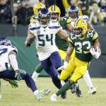 Green Bay Packers' Aaron Jones runs during the first half of an NFL divisional playoff football game against the Seattle Seahawks Sunday, Jan. 12, 2020, in Green Bay, Wis. (AP Photo/Mike Roemer)