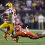 LSU wide receiver Justin Jefferson is tackled by Clemson safety K'Von Wallace during the second half of a NCAA College Football Playoff national championship game Monday, Jan. 13, 2020, in New Orleans. (AP Photo/Gerald Herbert)