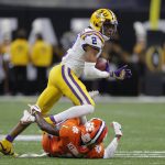 LSU wide receiver Justin Jefferson runs over Clemson cornerback Derion Kendrick during the first half of a NCAA College Football Playoff national championship game Monday, Jan. 13, 2020, in New Orleans. (AP Photo/Gerald Herbert)