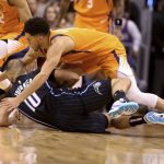 Phoenix Suns' Devin Booker (1) goes to the floor for a loose ball with Orlando Magic's Evan Fournier during the second half of an NBA basketball game Friday, Jan. 10, 2020, in Phoenix. (AP Photo/Darryl Webb)