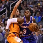 New York Knicks guard RJ Barrett (9) drives against Phoenix Suns guard Devin Booker in the first half of an NBA basketball game, Friday, Jan. 3, 2020, in Phoenix. (AP Photo/Rick Scuteri)
