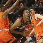 Arizona's Zeke Nnaji, center, maneuvers under the basket between Oregon State's Alfred Hollins, left, and Roman Silva during the first half of an NCAA college basketball game in Corvallis, Ore., Sunday, Jan. 12, 2020. (AP Photo/Chris Pietsch)