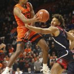 Oregon State's Ethan Thompson, left, passes the ball under pressure from Arizona's Chase Jeter, right, during the second half of an NCAA college basketball game in Corvallis, Ore., Sunday, Jan. 12, 2020. (AP Photo/Chris Pietsch)