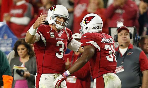 Quarterback Carson Palmer #3 of the Arizona Cardinals (left) celebrates a third quarter touchdown w...