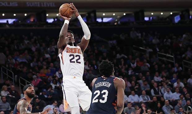 Phoenix Suns center Deandre Ayton (22) shoots with New York Knicks forward Marcus Morris Sr. (13) a...