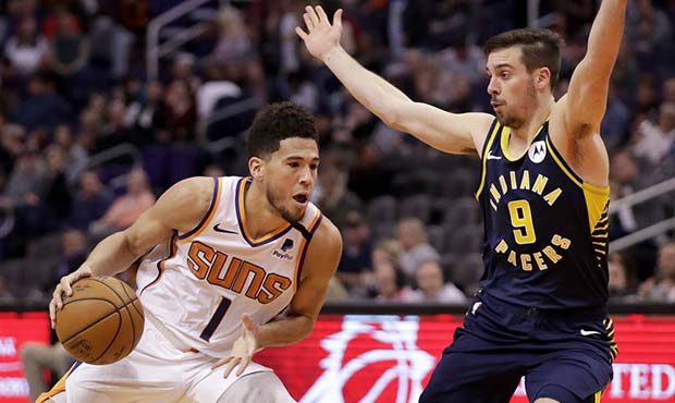 Phoenix Suns guard Devin Booker (1) drives as Indiana Pacers guard T.J. McConnell (9) defends durin...