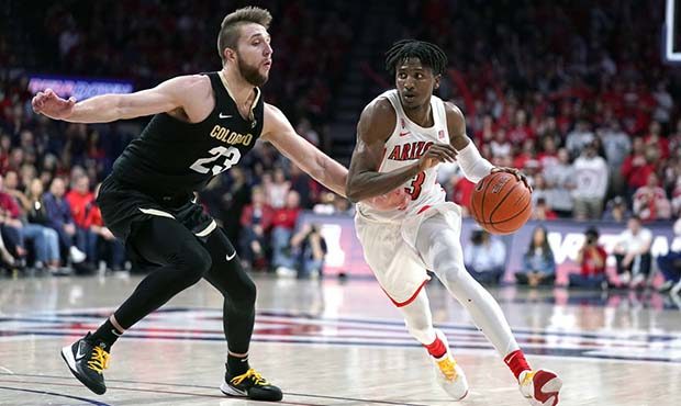 Arizona guard Dylan Smith (3) drives past Colorado forward Lucas Siewert during the second half of ...