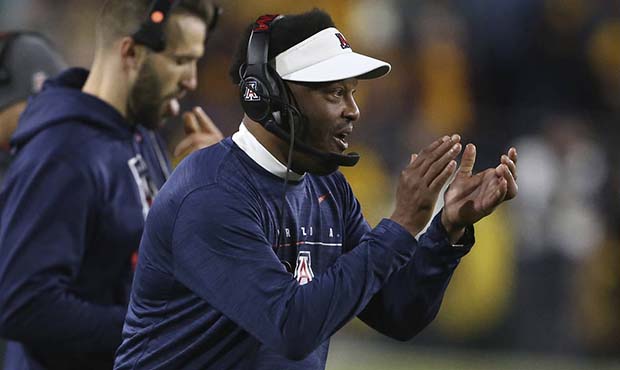 Arizona coach Kevin Sumlin claps in support of his team's defense against Arizona State during the ...