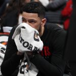 Houston Rockets guard Austin Rivers sits on the bench after word of the death of former NBA star Kobe Bryant before an NBA basketball game against the Denver Nuggets, Sunday, Jan. 26, 2020, in Denver. Bryant died in a California helicopter crash Sunday. (AP Photo/David Zalubowski)