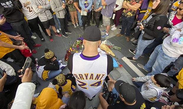 Fans mourn the loss of Kobe Bryant with makeshift memorials in front of La Live across from Staples...