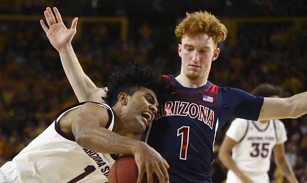 Arizona State guard Remy Martin, left, collides with Arizona guard Nico Mannion, right, during the ...
