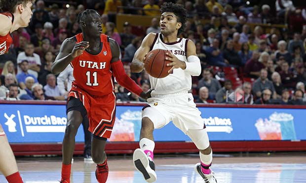 Arizona State guard Remy Martin, right, drives to the basket while Utah's Both Gach (11) defends du...