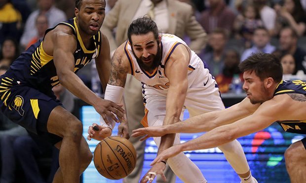 Phoenix Suns guard Ricky Rubio, center, loses the ball as Indiana Pacers forward T.J. Warren, left,...