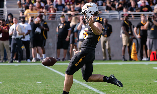 Arizona State Sun Devils punter Michael Turk (35) punts the ball during the college football game b...