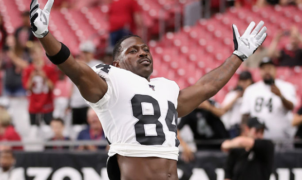 Wide receiver Antonio Brown #84 of the Oakland Raiders reacts to fans as he warms up before the NFL...
