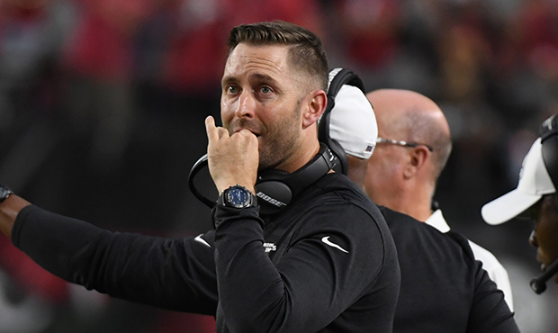 Head coach Kliff Kingsbury of the Arizona Cardinals watches a replay on the scoreboard during a gam...
