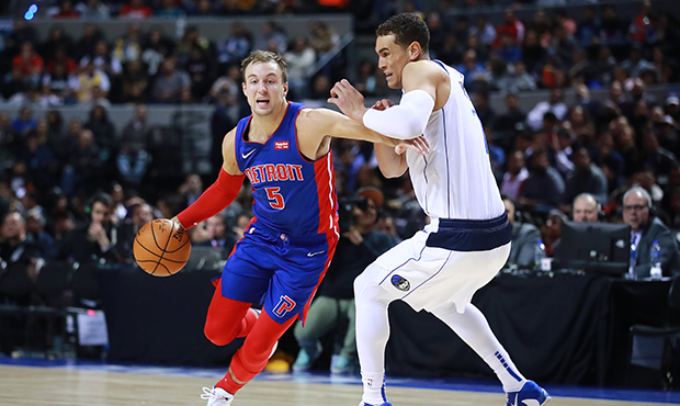 Luke Kennard #5 of the Detroit Pistons handles the ball against Dwight Powell #7 of the Dallas Mave...