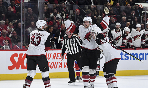 Taylor Hall #91 of the Arizona Coyotes celebrates with teammates after scoring a goal against the M...