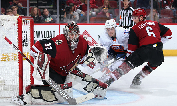 Goaltender Antti Raanta #32 of the Arizona Coyotes follows the play as Jakob Chychrun #6 defends Ma...