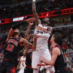 CHICAGO, ILLINOIS - FEBRUARY 22: Deandre Ayton #22 of the Phoenix Suns shoots over (L-R) Daniel Gafford #12, Coby White #0 and Ryan Arcidiacono #51 of the Chicago Bulls at the United Center on February 22, 2020 in Chicago, Illinois. The Suns defeated the Bulls 112-104. NOTE TO USER: User expressly acknowledges and agrees that, by downloading and or using this photograph, User is consenting to the terms and conditions of the Getty Images License Agreement. (Photo by Jonathan Daniel/Getty Images)