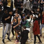 People gather around Orlando Magic's Aaron Gordon during basketball's NBA All-Star slam dunk contest Saturday, Feb. 15, 2020, in Chicago. (AP Photo/David Banks)