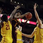 Arizona State guard Remy Martin (1) drives to the basket between Southern California forward Onyeka Okongwu (21) and forward Nick Rakocevic during the second half of an NCAA college basketball game Saturday, Feb. 29, 2020, in Los Angeles. (AP Photo/Marcio Jose Sanchez)