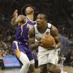Milwaukee Bucks' Eric Bledsoe, right, drives against the Phoenix Suns during the first half of an NBA basketball game Sunday, Feb. 2, 2020, in Milwaukee. (AP Photo/Jeffrey Phelps)