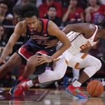 Arizona forward Zeke Nnaji, left, and Southern California guard Ethan Anderson go after a loose ball during the first half of an NCAA college basketball game Thursday, Feb. 27, 2020, in Los Angeles. (AP Photo/Mark J. Terrill)