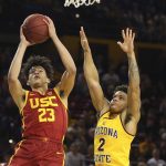 Southern California forward Max Agbonkpolo (23) scores against Arizona State guard Rob Edwards (2) during the first half of an NCAA college basketball game Saturday, Feb. 8, 2020, in Tempe, Ariz. (AP Photo/Ross D. Franklin)