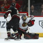 Chicago Blackhawks goaltender Corey Crawford (50) makes a save on a shot from Arizona Coyotes center Nick Schmaltz (8) during a shootout in an NHL hockey game Saturday, Feb. 1, 2020, in Glendale, Ariz. (AP Photo/Ross D. Franklin)