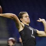 Oregon quarterback Justin Herbert runs a drill at the NFL football scouting combine in Indianapolis, Thursday, Feb. 27, 2020. (AP Photo/Charlie Neibergall)