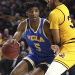 UCLA's Chris Smith (5) looks for an opening while being covered by Arizona State's Tahshon Cherry (35) during the first half of an NCAA college basketball game Thursday, Feb. 6, 2020, in Tempe, Ariz. (AP Photo/Darryl Webb)